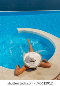 Woman With Hat At The Swimming Pool