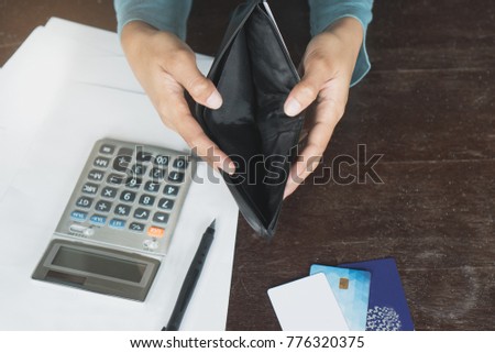 Woman have a financially broke from due of credit card debt payday. person opening empty wallet no money in wallet.