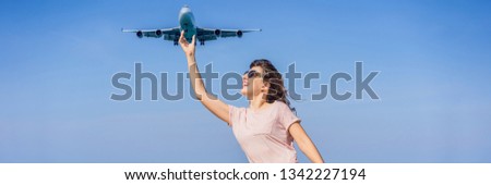 Woman have fun on the beach watching the landing planes. Traveling on an airplane concept. Text space. Island Phuket in Thailand. Impressive paradise. Hot beach Mai Khao. Amazing landscape BANNER