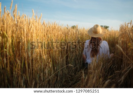 Similar – Woman alone in a field of wheat