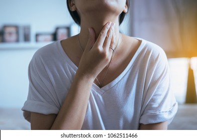 Woman have a sore throat,Female touching neck with hand,Healthcare Concepts,Bone stuck in throat