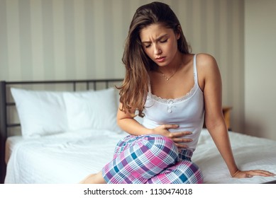 Woman Have A Stomachache In Bedroom Because Menstruation