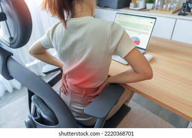 Woman having back body pain during work long time on workplace. due to Piriformis, Low Back, waist ache, lumbago, kidney, rheumatism and Spinal Compression. Office syndrome and Ergonomic concept - Shutterstock ID 2220368701