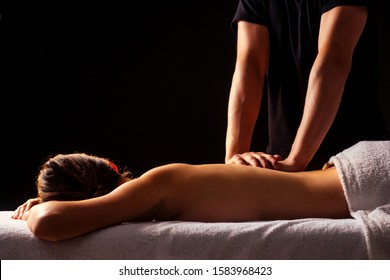 woman having back therapy yoga massaging in gym spa.