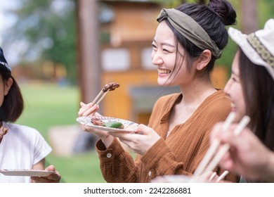 A woman having a BBQ at the camp - Powered by Shutterstock