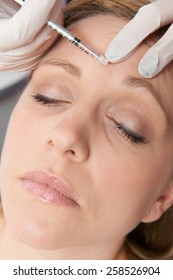 Woman Having Botox Injection In Forehead