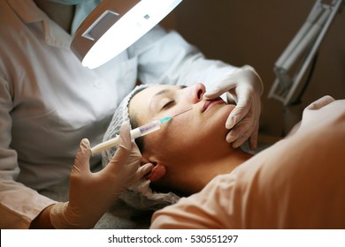Woman Having Botox Treatment In Beauty Salon.