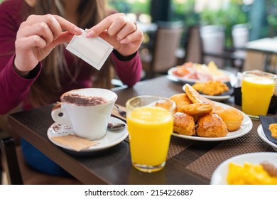 Woman Having Breakfast With Cappuccino, Sweet Pastries And Orange Juice