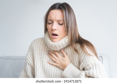 Woman having breath difficulties. Shortness of breath. Coronavirus cough breathing problem - Shutterstock ID 1914711871