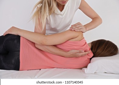 Woman Having Chiropractic Back Adjustment. Osteopathy, Physiotherapy, Sport Injury Rehabilitation Concept, Holistic Care