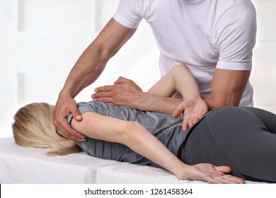 Woman having chiropractic back adjustment. Osteopathy, Physiotherapy, sport injury rehabilitation concept, holistic care - Powered by Shutterstock