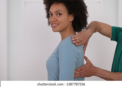 Woman Having Chiropractic Back Adjustment. Osteopathy, Physiotherapy, Injury Rehabilitation Concept