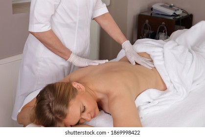 Woman Having Chiropractic Back Adjustment. Osteopathy, Alternative Medicine, Pain Relief Concept.