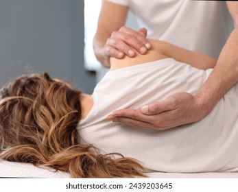 Woman having Chiropractic back adjustment. Osteopathy, Physiotherapy, Sport Injury rehabilitation - Powered by Shutterstock