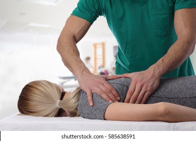 Woman having chiropractic back adjustment. Osteopathy, Alternative medicine, pain relief concept. Physiotherapy, sport injury rehabilitation - Shutterstock ID 585638591