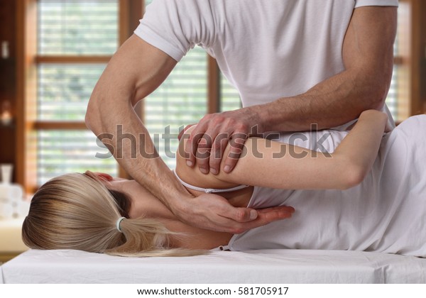Woman having chiropractic back adjustment.\
Osteopathy, Alternative medicine, pain relief concept.\
Physiotherapy, sport injury\
rehabilitation
