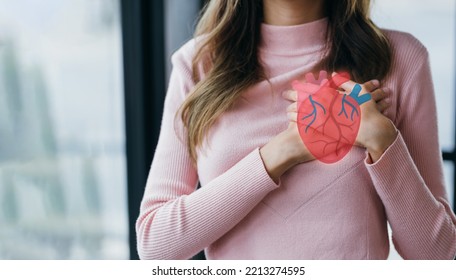 Woman having clutching chest with heart anatomy, heart attack, heart disease, Female with health care and Healthy feminine, World Heart Day concept.
