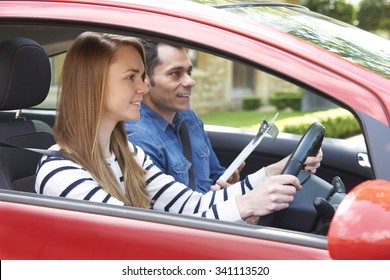 Woman Having Driving Lesson With Instructor