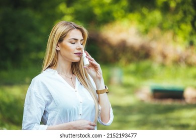 Woman is having flu and she is using nasal spray to help herself. Woman using nasal spray. Nasal spray to help a cold. Sick with a rhinitis woman dripping nose. Woman applies nasal spray