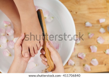 Woman having foot care treatment in beauty salon