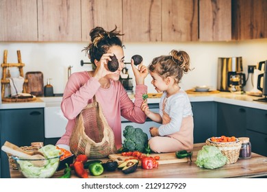 Woman having fun with her daughter while preparing food in the kitchen. - Powered by Shutterstock