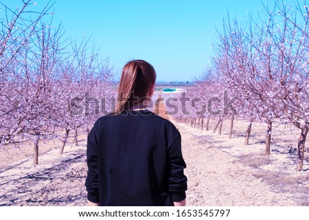 Woman having fun with sakura trees