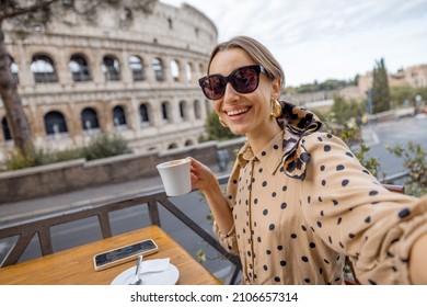 Woman Having Fun Taking Selfie With Coffee At Outdoor Cafe On Background Of Coliseum, The Most Famous Landmark In Rome. Concept Of Italian Lifestyle And Traveling Italy