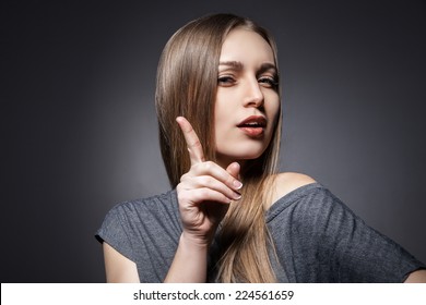 Woman Having A Good Idea On Dark Grey Background