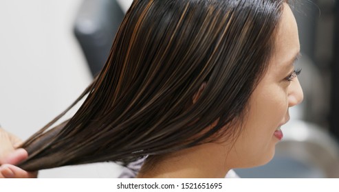 Woman Having Hair Treatment In Hair Salon