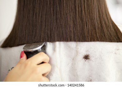 Woman Having A Haircut With A Hair Clippers
