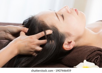 The Woman Is Having A Head Massage.