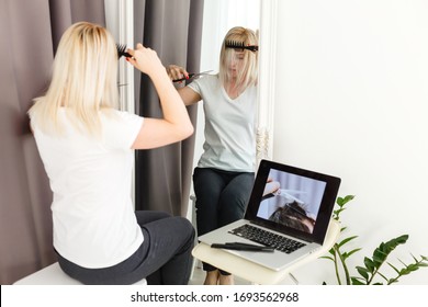 Woman Having Her Hair Cut At Home During The Coronavirus Pandemic, , Online Hairdressing Learning On A Laptop