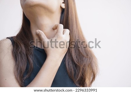 Woman having itchy skin on the neck