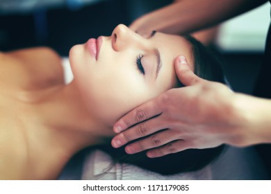 Woman having a massage in a spa - Shutterstock ID 1171179085