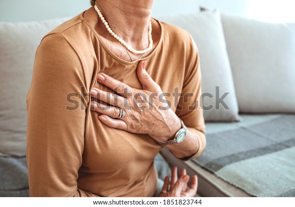 Woman having a pain in the heart area.\
Heart Attack. Painful Chest. Health Care, Medical Concept. High\
Resolution. Woman having heart attack at home.\
