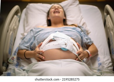 A Woman Having Painful Contractions Lying In The Hospital Bed Waiting For Labor.