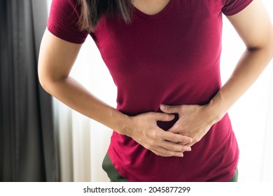 Woman Having Painful Stomachache At Home. Chronic Gastritis. Abdomen Bloating Concept