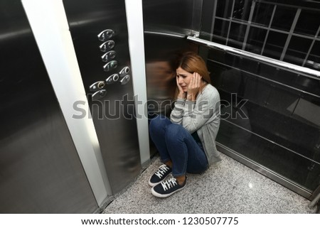 Woman having panic attack in elevator