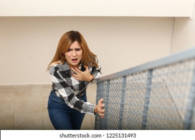 Woman having panic attack while walking upstairs