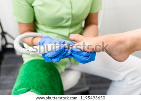 Woman having pedicure treatment in a modern beauty salon.