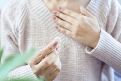 Woman Having Problem With Heartburn From Acid Reflux Disease Hand Taking Antacid Medicine For GERD Treatment 