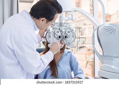 Woman having problem of short eyesight. She smiling and doing eye test by Ophthalmologist in optical lab.