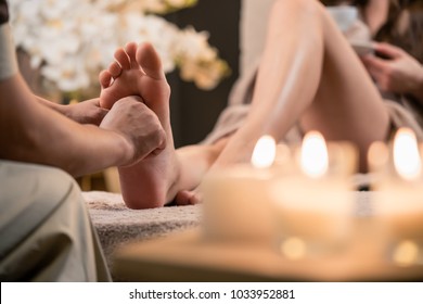 Woman Having Reflexology Foot Massage In Wellness Spa Center