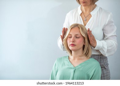 Woman having reiki healing treatment , alternative medicine concept, holistic care. Close Up Of A Relaxed Young Woman Having Reiki Healing Treatment. Alternative medicine and holistic health care. - Powered by Shutterstock