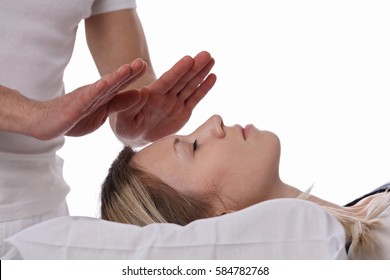 Woman having reiki healing treatment , alternative medicine concept.