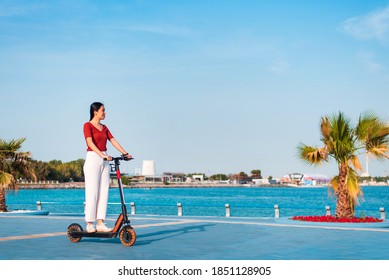 Woman having a ride on electric scooter for quick and easy transportation in a modern city life - Powered by Shutterstock
