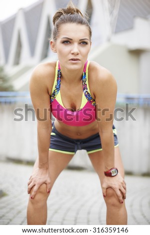 Similar – Young woman stretching arms before training outdoors