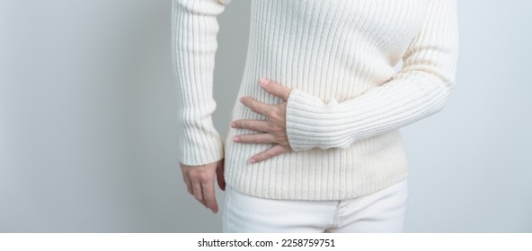 woman having side back pain. Urinary system and Stones, Cancer, world kidney day, Chronic kidney stomach, liver pain and pancreas concept - Shutterstock ID 2258759751