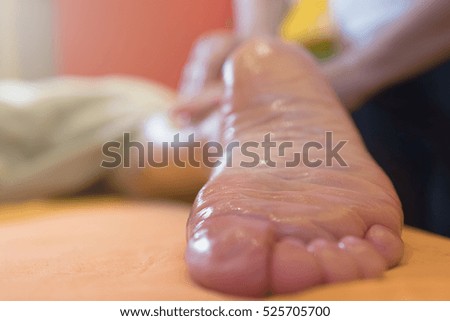 Woman having sports foot massage in Spa Salon. Close-up Of Woman Feet Receiving Foot Massage In Spa