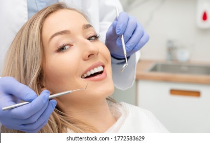 Woman having teeth examined at dentists. Teeth whitening, dental care concept